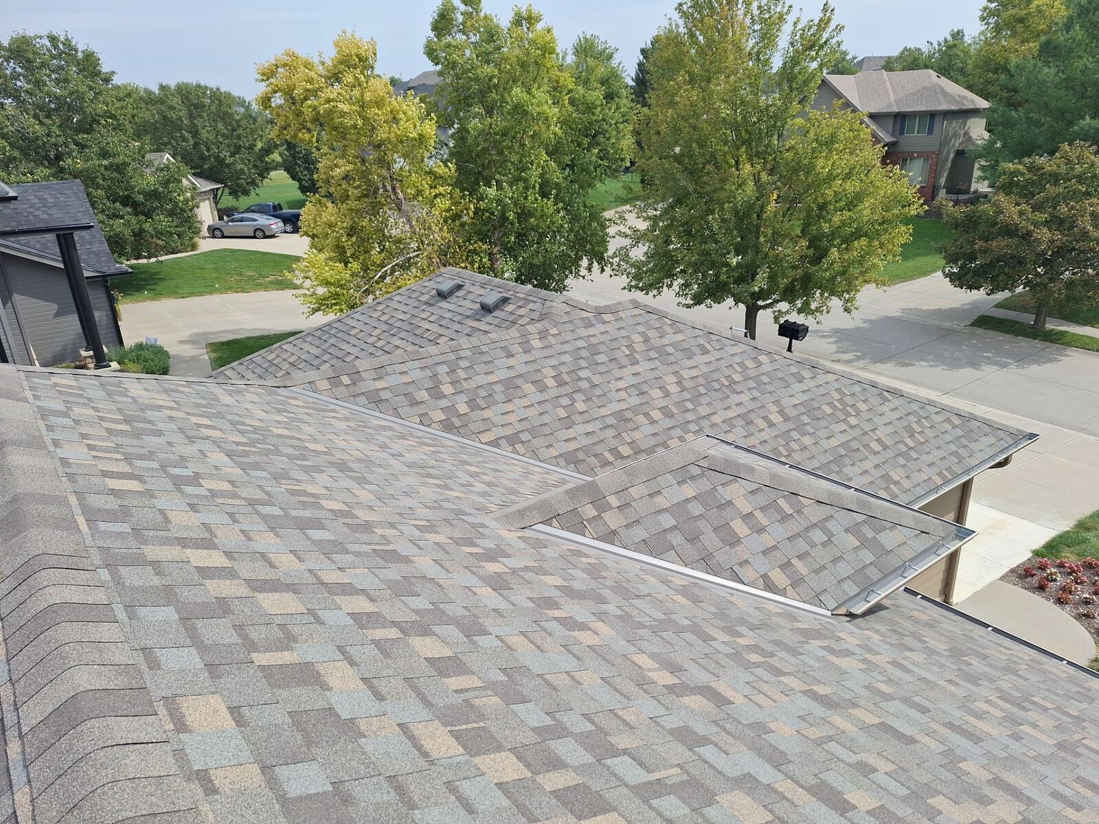 Slusky Construction crew installing shingles on an Omaha roof